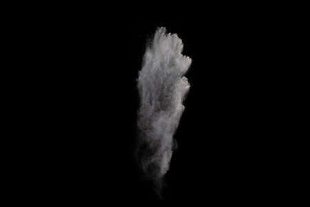 White powder explosion on black background. Colored cloud. Colorful dust explode. Paint Holi.
