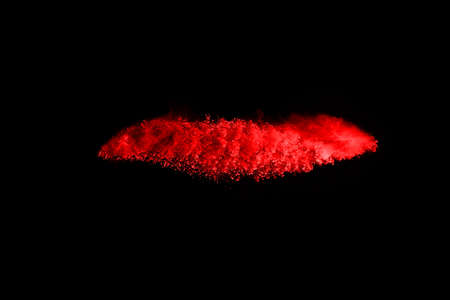 abstract red powder explosion on black background.abstract red powder splatted on black background....