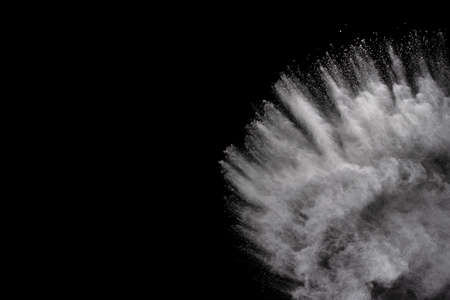 White powder explosion on black background. Colored cloud. Colorful dust explode. Paint Holi.