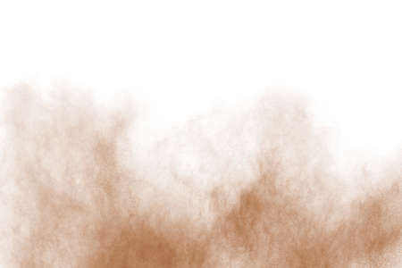 Brown color powder explosion on white background. Colored cloud. Colorful dust explode. Paint Holi.