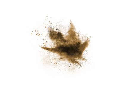 Brown color powder explosion on white background. Colored cloud. Colorful dust explode. Paint Holi.の写真素材