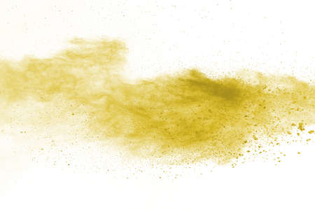 Powder explosion. Closeup of a yellow dust particle explosion isolated on white. Abstract background