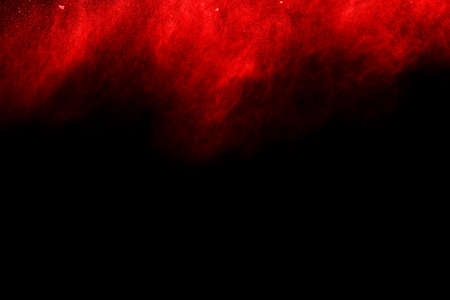 abstract red powder explosion on black background.abstract red powder splatted on black background. Freeze motion of red powder exploding.の写真素材