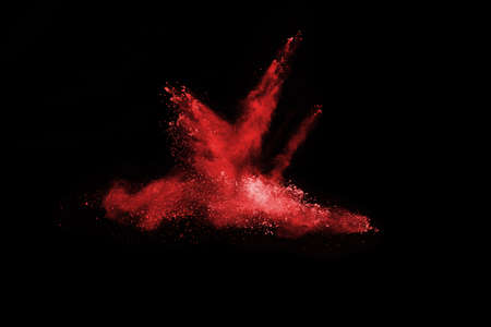 abstract red powder explosion on black background.abstract red powder splatted on black background....