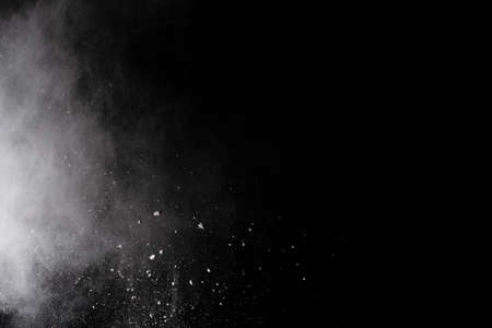 White powder explosion on black background. Colored cloud. Colorful dust explode. Paint Holi.
