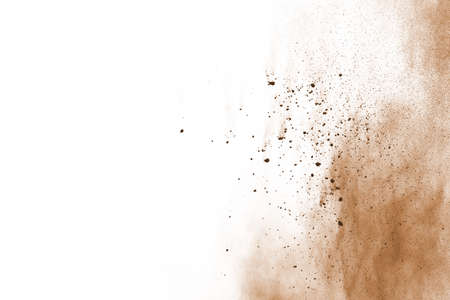 Brown color powder explosion on white background. Colored cloud. Colorful dust explode. Paint Holi.の写真素材