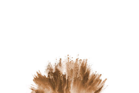 Brown color powder explosion on white background. Colored cloud. Colorful dust explode. Paint Holi.