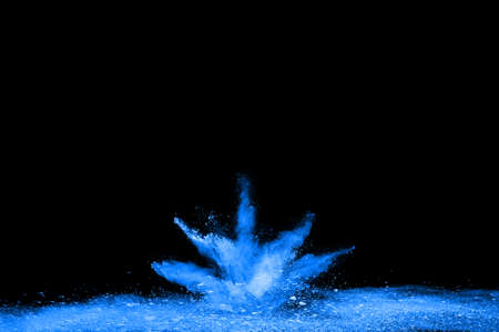 Blue powder explosion on black background. Colored cloud. Colorful dust explode. Paint Holi.の写真素材