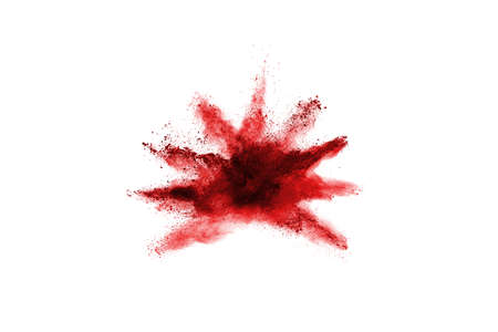 Freeze motion of red powder exploding, isolated on white background. Abstract design of red dust...