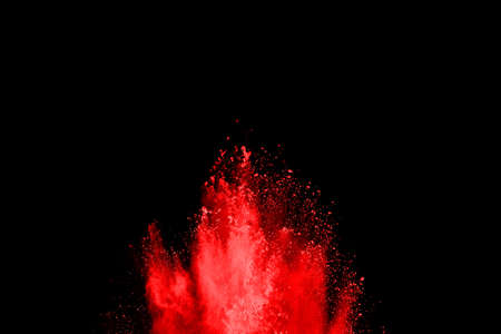 abstract red powder explosion on black background.abstract red powder splatted on black background....