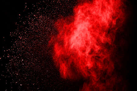 abstract red powder explosion on black background.abstract red powder splatted on black background. Freeze motion of red powder exploding.の写真素材