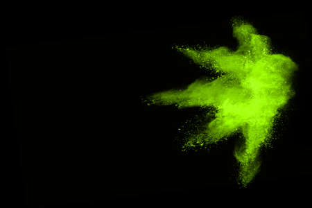 The movement of abstract dust explosion frozen green on black background. Stop the movement of...