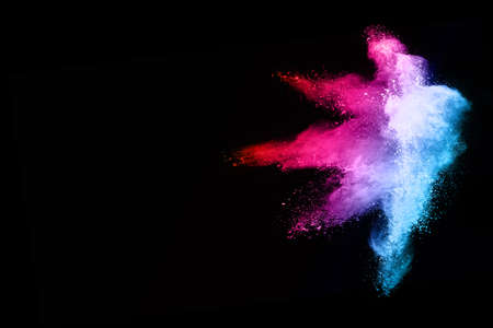 Abstract colored dust explosion on a black background.abstract powder splatted background,Freeze...