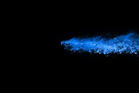 abstract blue powder splatted background,Freeze motion of color powder exploding/throwing color powder,color glitter texture on black background.の写真素材