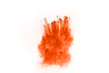 Orange powder explosion on white background. Paint Holi.の写真素材