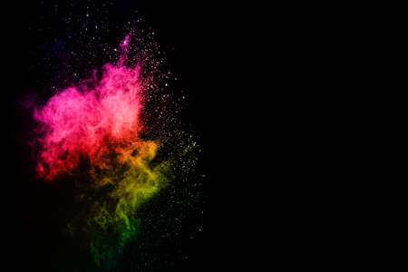 Abstract colored dust explosion on a black background.abstract powder splatted background,Freeze motion of color powder exploding/throwing color powder, multicolored glitter texture.の写真素材