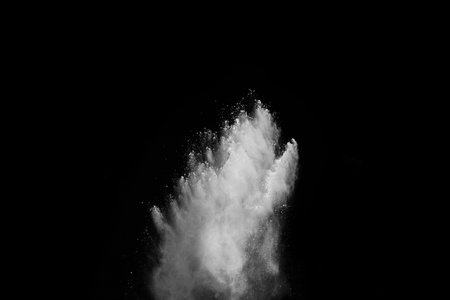 White powder explosion on black background. Colored cloud. Colorful dust explode. Paint Holi.の写真素材