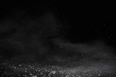 White powder explosion on black background. Colored cloud. Colorful dust explode. Paint Holi.の写真素材