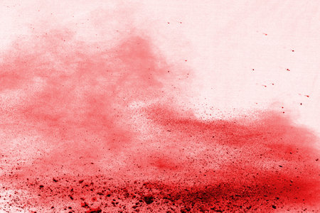Freeze motion of red powder exploding, isolated on white background. Abstract design of red dust cloud. Particles explosion screen saver, wallpaperの写真素材