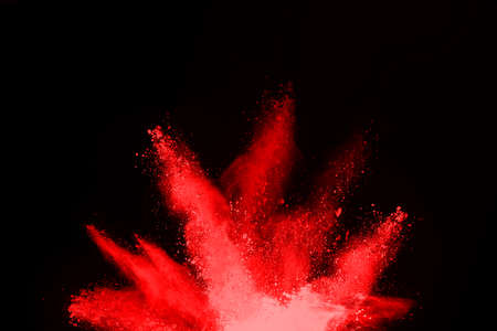 abstract red powder explosion on black background.abstract red powder splatted on black background....