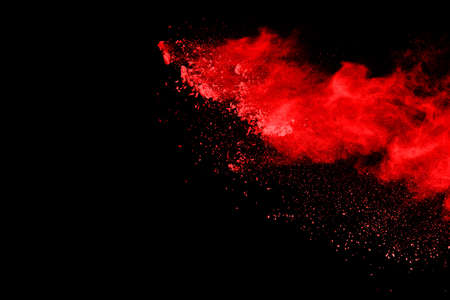 abstract red powder explosion on black background.abstract red powder splatted on black background. Freeze motion of red powder exploding.の写真素材