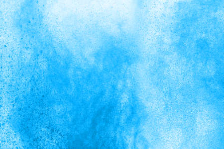 Blue color powder explosion on white background. Colored cloud. Colorful dust explode. Paint Holi.の写真素材