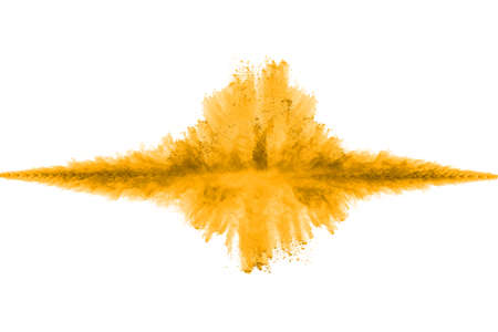 Powder explosion. Closeup of a yellow dust particle explosion isolated on white. Abstract background