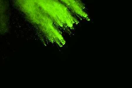 The movement of abstract dust explosion frozen green on black background. Stop the movement of...
