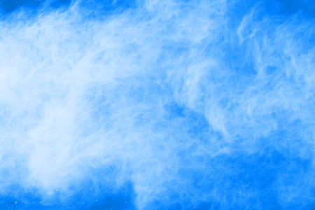 Blue color powder explosion on white background. Colored cloud. Colorful dust explode. Paint Holi.の写真素材