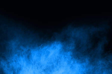 abstract blue powder splatted background,Freeze motion of color powder exploding/throwing color powder,color glitter texture on black background.の写真素材