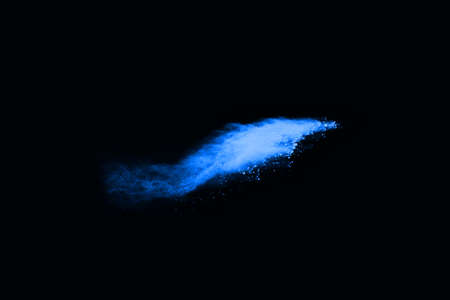 abstract blue powder splatted background,Freeze motion of color powder exploding/throwing color powder,color glitter texture on black background.の写真素材