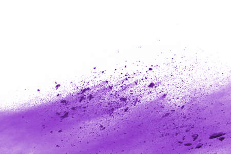 Powder explosion. Closeup of a purple dust particle explosion isolated on white. Abstract background.の写真素材
