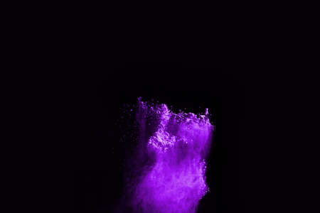 The movement of abstract dust explosion frozen purple on black background. Stop the movement of powdered purple on black background. Explosive powder purple on black background.の写真素材