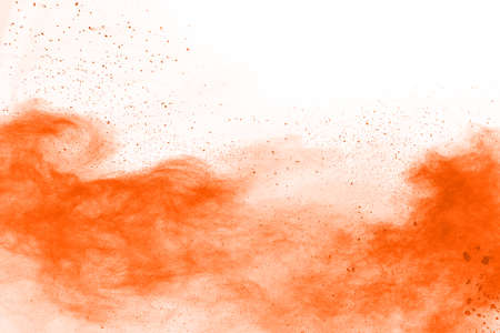 Orange powder explosion on white background. Paint Holi.の写真素材