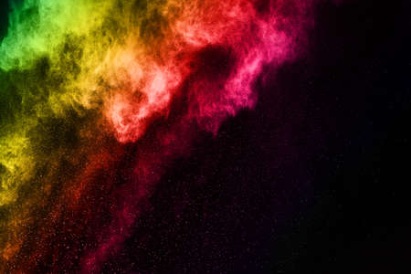 Abstract colored dust explosion on a black background.abstract powder splatted background,Freeze motion of color powder exploding/throwing color powder, multicolored glitter texture.の写真素材