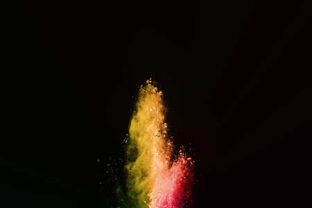 Abstract colored dust explosion on a black background.abstract powder splatted background,Freeze...