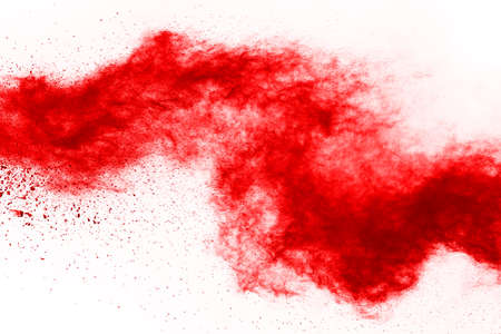 Freeze motion of red powder exploding, isolated on white background. Abstract design of red dust cloud. Particles explosion screen saver, wallpaperの写真素材