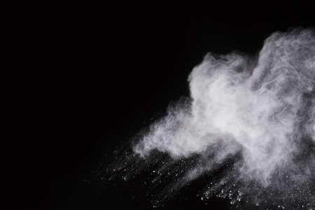 White powder explosion on black background. Colored cloud. Colorful dust explode. Paint Holi.