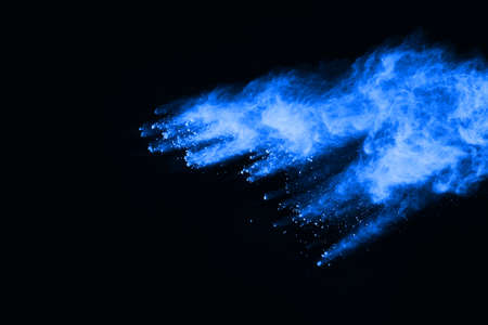 abstract blue powder splatted background,Freeze motion of color powder exploding/throwing color powder,color glitter texture on black background.の写真素材