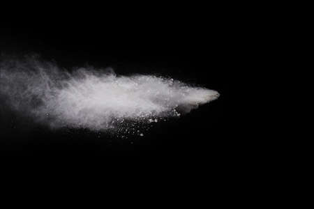 White powder explosion on black background. Colored cloud. Colorful dust explode. Paint Holi.の写真素材