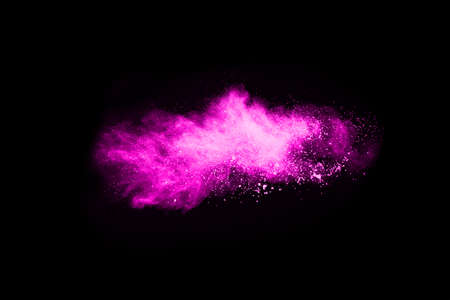 Pink powder explosion on black background. Colored cloud. Colorful dust explode. Paint Holi.
