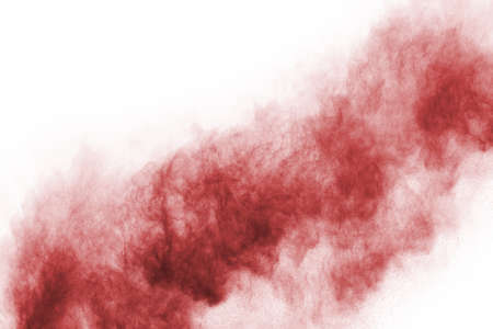 Freeze motion of red powder exploding, isolated on white background. Abstract design of red dust cloud. Particles explosion screen saver, wallpaperの写真素材