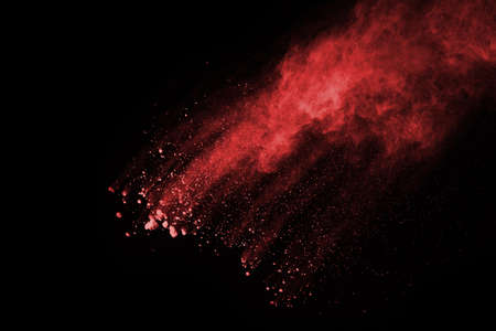 abstract red powder explosion on black background.abstract red powder splatted on black background. Freeze motion of red powder exploding.の写真素材