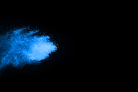 abstract blue powder splatted background,Freeze motion of color powder exploding/throwing color powder,color glitter texture on black background.の写真素材