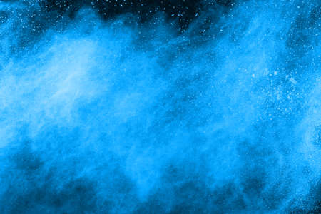 abstract blue powder splatted background,Freeze motion of color powder exploding/throwing color...