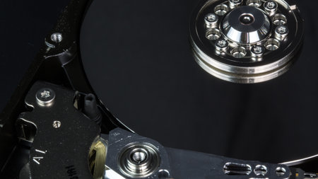 Disassembled hard drive from the computer, hdd with mirror effect Opened hard drive from the computer hdd with mirror effects Part of computer pc, laptop Closeup HDDの写真素材