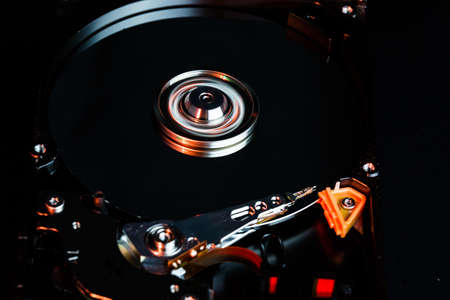 Disassembled hard drive from the computer, hdd with mirror effect Opened hard drive from the computer hdd with mirror effects Part of computer pc, laptop Closeup HDDの写真素材