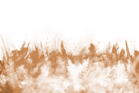 Brown color powder explosion on white background. Colored cloud. Colorful dust explode. Paint Holi.の写真素材