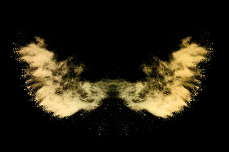 Explosion of yellow powder on black background. Abstract colored cloud.の写真素材