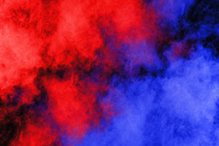 Abstract blue and red powder explosion on black background. Colorful cloud.の写真素材